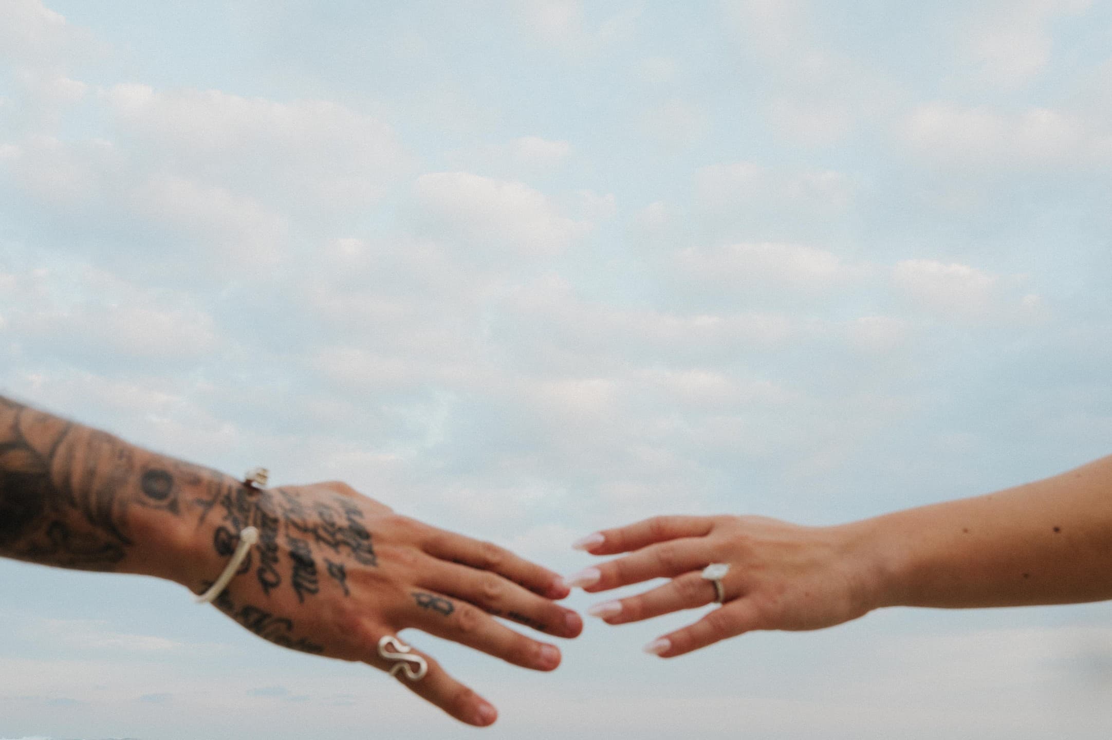Ming and Gavin reaching for each other's hands